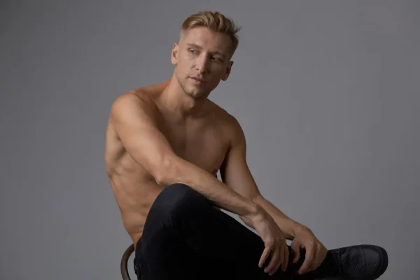 Topless man looking more sculpted after neck lipo recovery