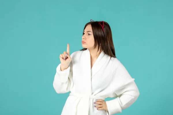 Woman wearing a robe and thinking what to prepare for her FaceTite appointment