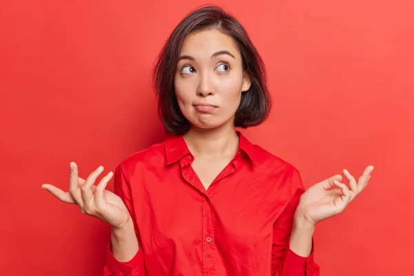 Woman wearing red blouse and thinking of what to do after getting her PDO threads