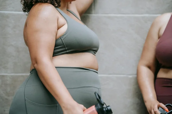 Woman wearing sportswear and looking more sculpted after getting tummy tuck for her FUPA