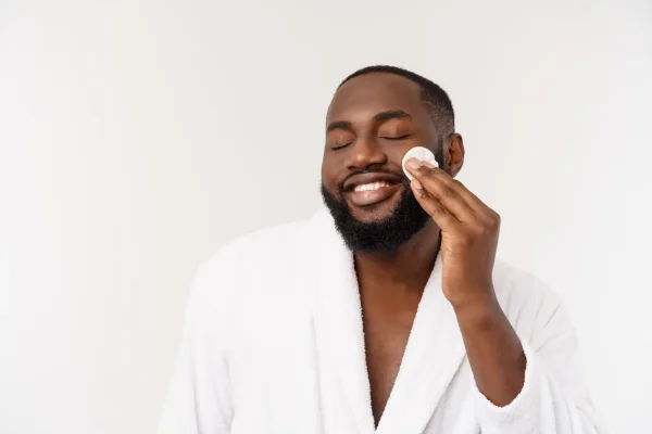 Man doing skincare and maintaining the beautiful results of his plastic surgery