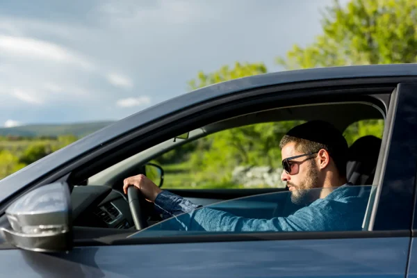 Man driving again after neck liposuction recovery