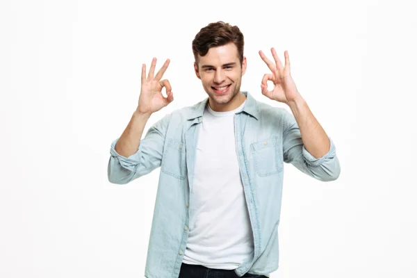 Man raising both hands doing okay signs and looking happy after plastic surgery