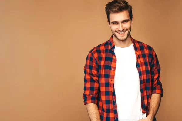 Man wearing checkered flannel shirt and looking very happy after seeing his Botox results