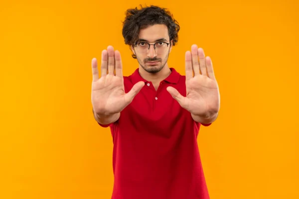 Man wearing red shirt and showing both hands to show red flags about Botox resistance