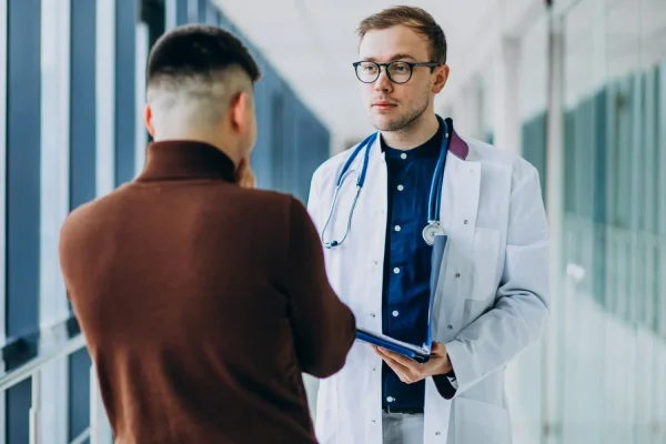 Plastic surgeon talking to a patient about CJC-1295 peptide therapy
