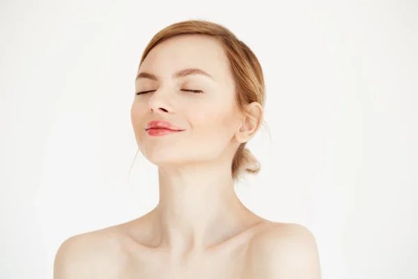 Shirtless woman looking happy after getting a non surgical treatment for her double chin