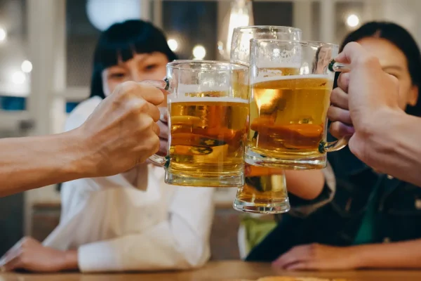 A group of friends drinking alcohol and talking about Botox procedures