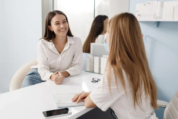 Beautiful woman consulting with a cosmetic surgeon about liposuction
