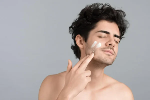 Man applying skincare after Botox appointment