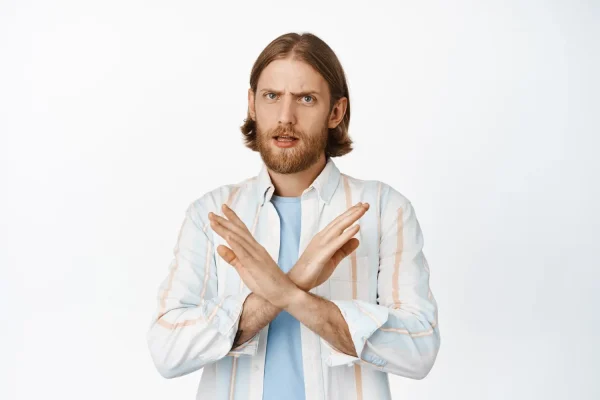 Man doing a disagree pose to warn people not to go the cheap route when considering plastic surgery