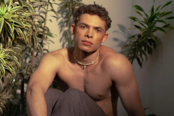 Man sitting and showing off his sculpted physique after recovering from HD liposuction
