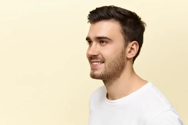 Man smiling wearing white shirt after FaceTite recovery