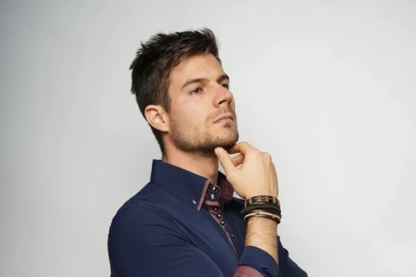 Man touching his chin and wondering if PDO threads continue to tighten
