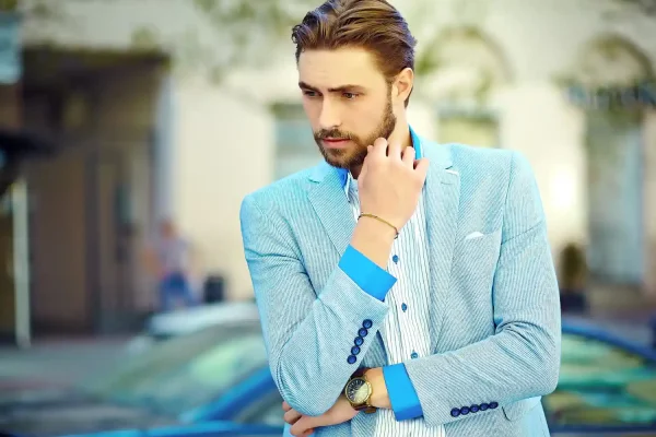 Man wearing blue coat and looking more handsome than ever after getting jawline fillers