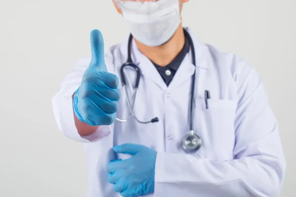 Medium shot of a plastic surgeon with a thumbs up pose after recommending PDO threads