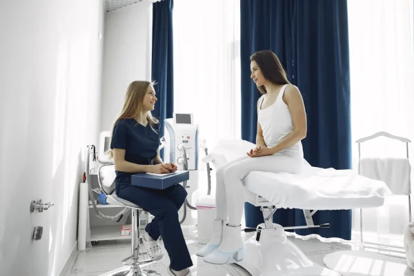 Plastic surgeon discussing postoperative recovery from liposuction with a patient