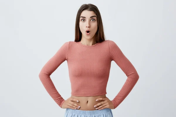 Woman looking shocked and suspecting that she may have a bad high definition liposuction result
