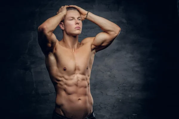 A fit man with prominent abdominal muscles after body contouring procedures like liposuction