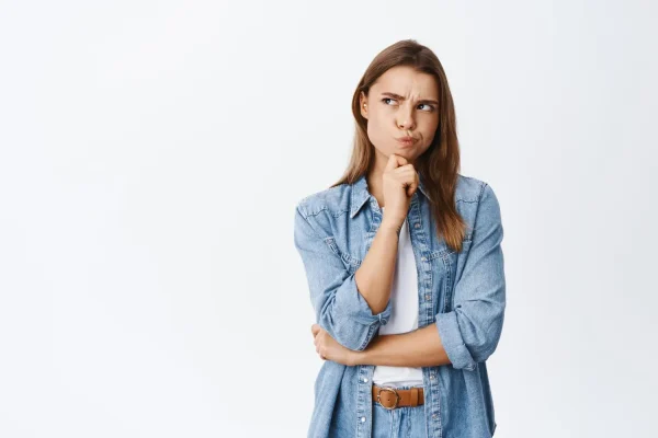 A woman thoughtfully considering her neck liposuction options