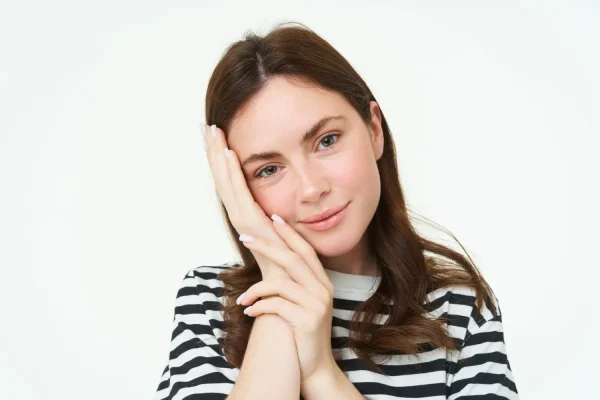 A woman with a smooth, contoured neck and jawline showcasing the refined results of combining a neck lift with neck liposuction