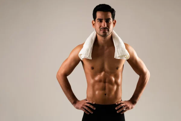 Athletic man with towel ready for post-workout recovery emphasizing the importance of support during surgical healing