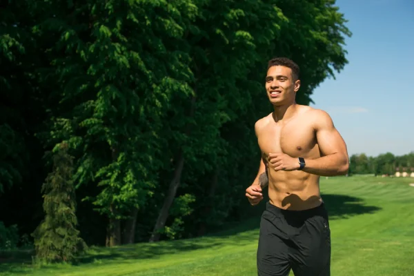 Fit man jogging outdoors to achieve optimal weight before plastic surgery