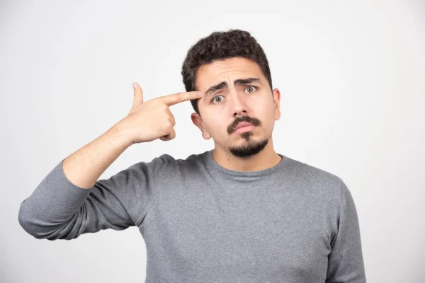 Man pointing to his eyebrow area while considering whether to wax before Botox treatment