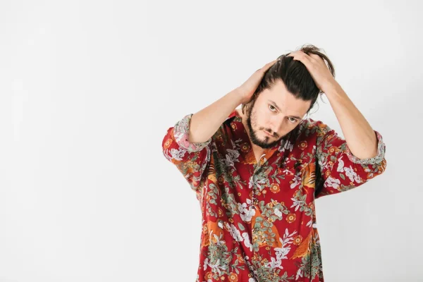 Man running hands through hair while learning about understanding PRP hair treatment