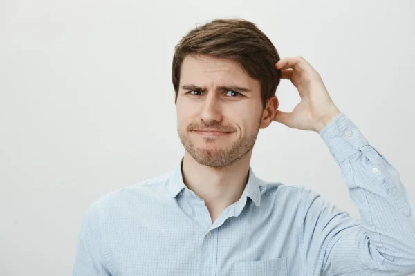 Man scratching head wondering about activities to avoid after PRP treatment