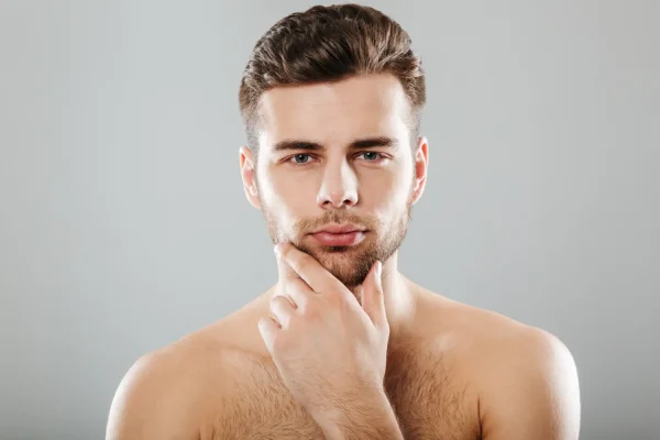 Man touching his jawline highlighting the importance of sun protection after FaceTite