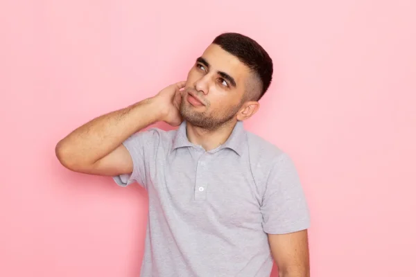 Man touching his neck while considering liposuction recovery options