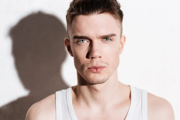 Man with chiseled jawline and firm skin showcasing enhanced FaceTite results from complementary treatments