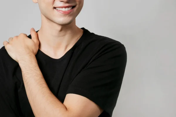 Smiling man with smooth, firm neck skin showcasing the benefits of laser treatment for neck tightening