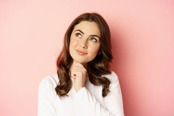 Woman considering if she is a good candidate for non-surgical tummy tuck