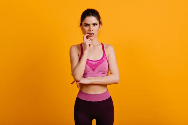 Woman in athletic wear looking thoughtful, reflecting how Selank works