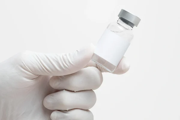 hand holding medicine glass vial