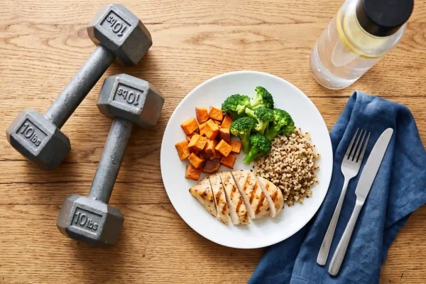 High-protein meal and dumbbells that support fat loss peptide results
