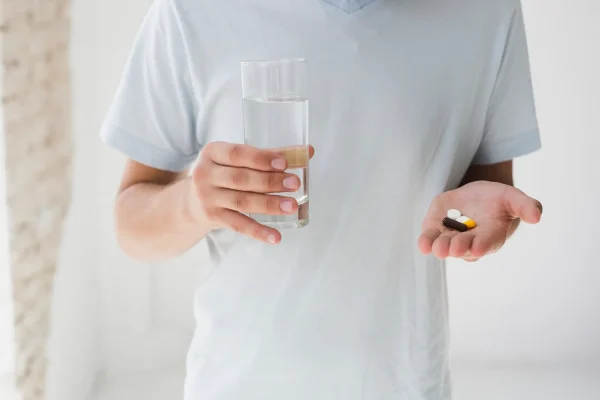 man-with-pills-water