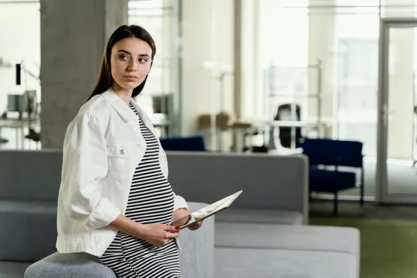 Pregnant woman working at the office