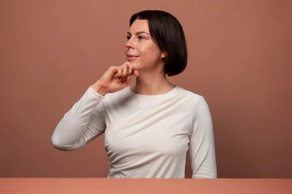 Side view woman practicing facial yoga