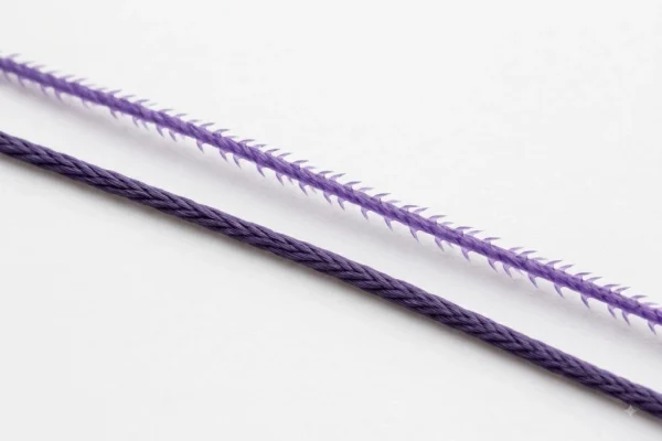 Close-up comparing a smooth mono thread with a barbed PDO thread