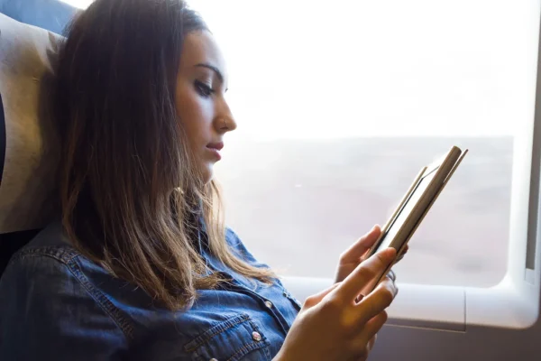 Woman reading a book in a plane