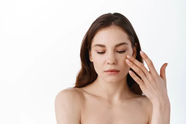 woman touching her face