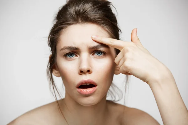 woman touching her forehead