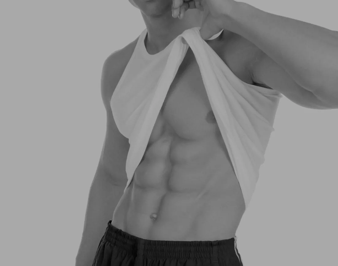 model with shirt raised to show ab muscles