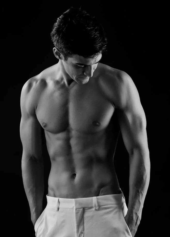 Black and white photo of shirtless male model.