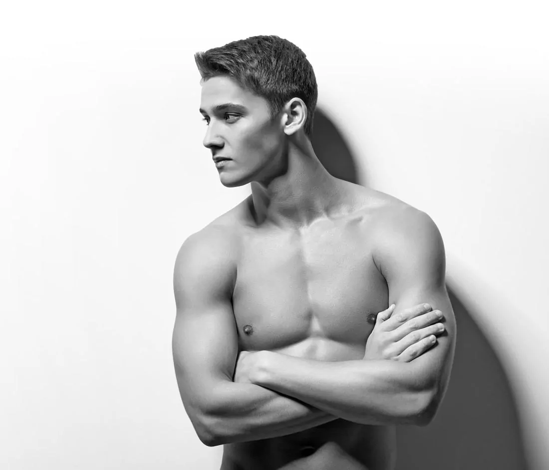 Black and white portrait of a shirtless man.