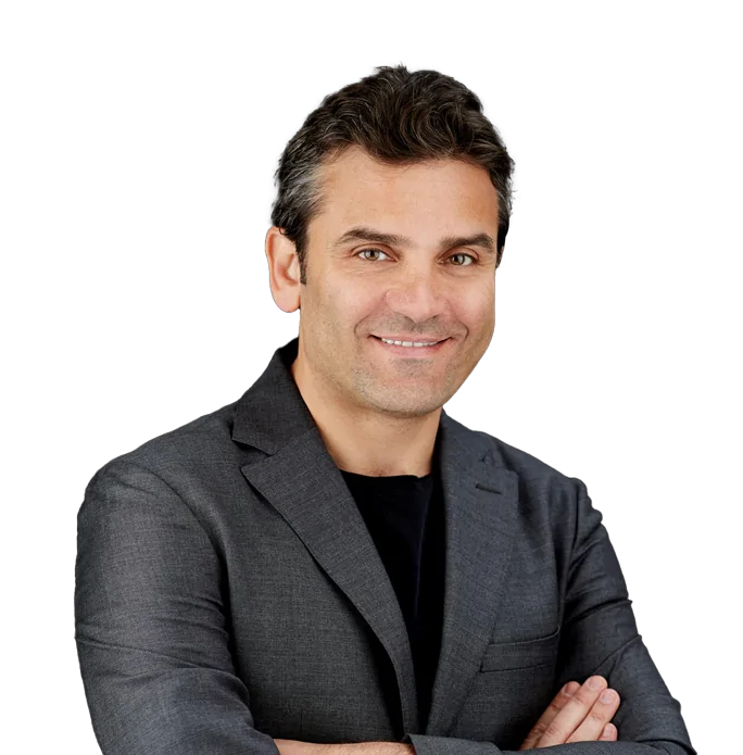 Dr. Ahmad Saad in gray suit on black background.