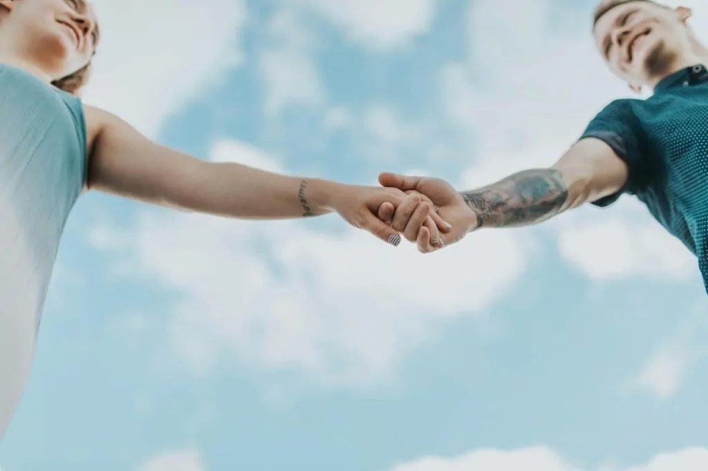 A couple holding each others hands